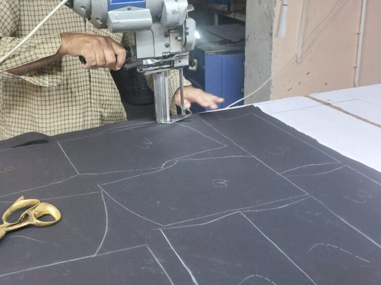 Fabric being cut for custom activewear production at GYMHUR's factory in Sialkot, Pakistan